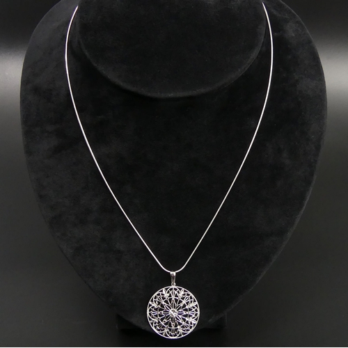 7 - 9 carat white gold pendant and chain, 5.4 grams. 28 mm diameter, chain 45 cm. UK Postage £12.
