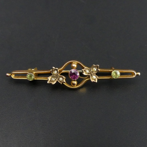 41 - 9 carat gold bar brooch stone set with Suffragette colours, 2.1 grams. 48 mm long. UK Postage £12.