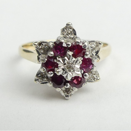 25 - 9 carat gold ruby and diamond cluster ring, 3.8 grams. Size R, 14 mm wide. UK Postage £12.