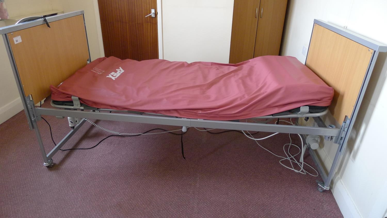 A modern electrically operated rise and fall patient's bed with An Apex ...