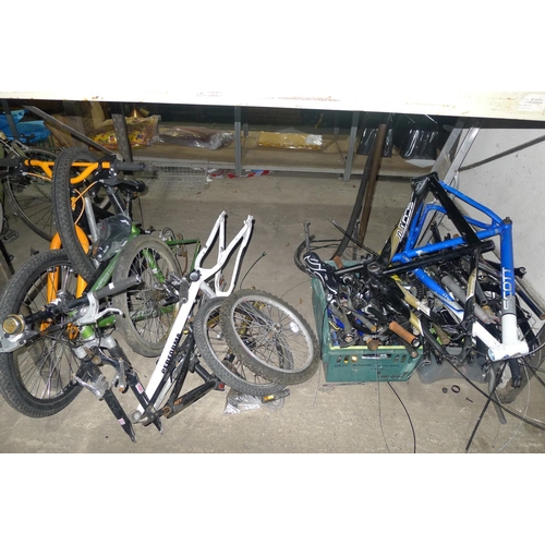 52 - A large quantity of bicycle related items including 5 bicycle frames, forks, handlebars etc. Content... 