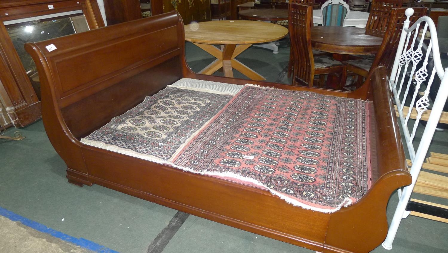 A large mahogany sleigh bed with 5ft 6" spring base