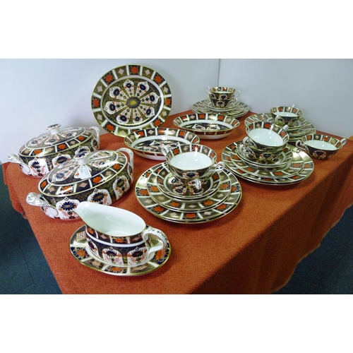 334 - A Royal Crown Derby old Imari 1128 dinner service comprising; 2 tureens, gravy boat & saucer, oval m... 