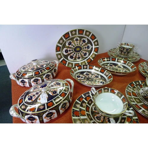 334 - A Royal Crown Derby old Imari 1128 dinner service comprising; 2 tureens, gravy boat & saucer, oval m... 
