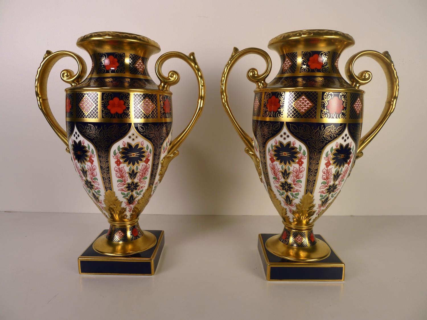 A pair of Royal Crown Derby old Imari 1128 two handled Thorpe vases