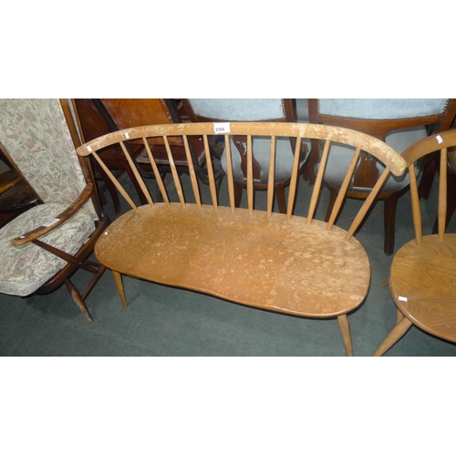 2384 - A vintage Ercol light wood rail back two-seater settle. Please note the horizontal rail has been rep... 
