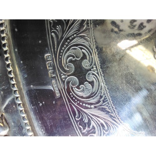 3151 - (H1) a large oval engraved silver tea tray with two handles approximately 59 cm long weighing approx... 