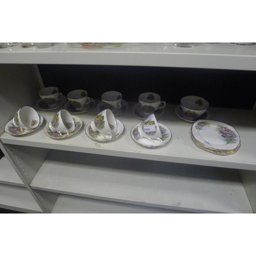 2043 - A quantity of cottage patterned Royal Vale tea cups, saucers and plates (1 shelf)