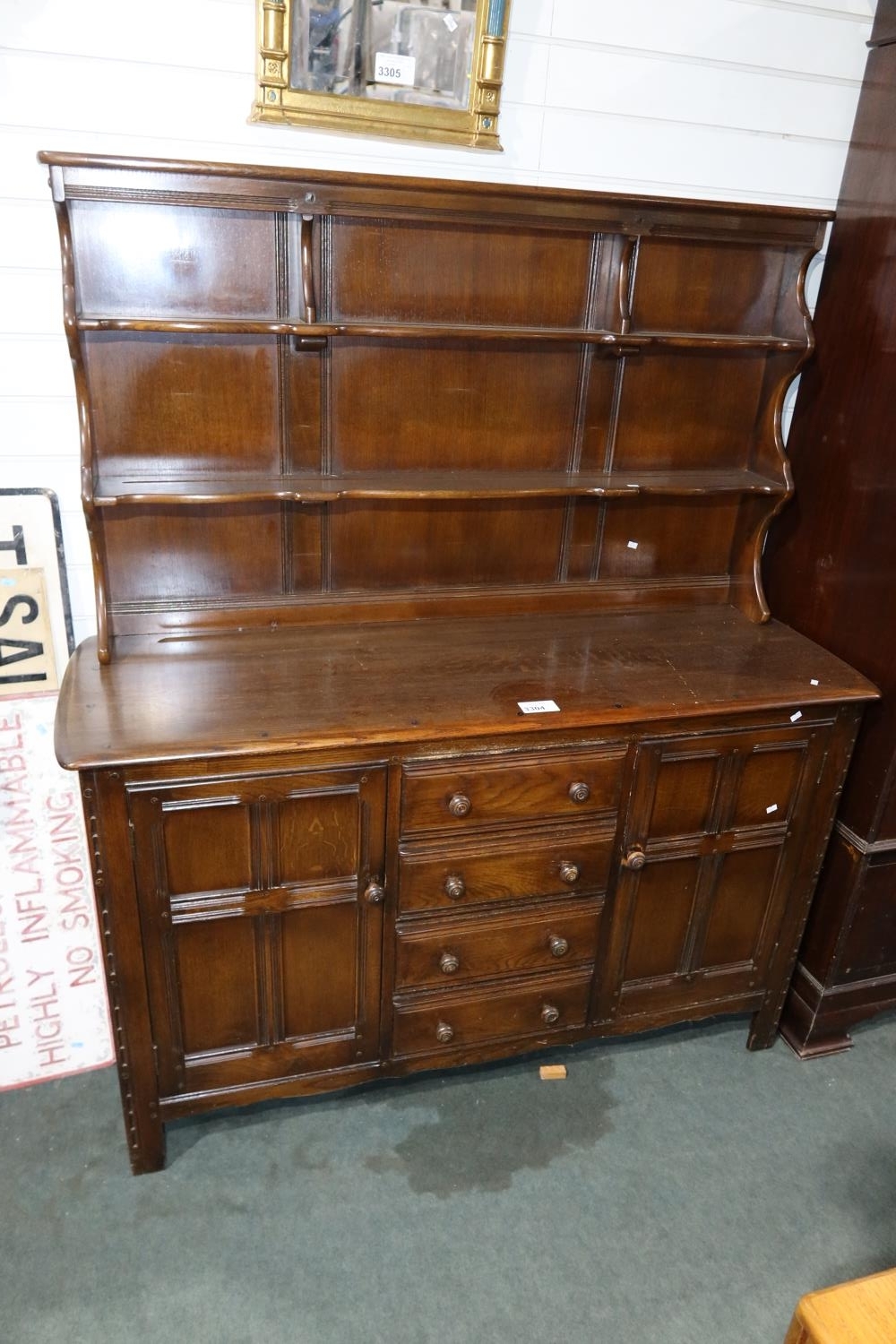 Vintage Ercol dark wood dresser with open shelves drawers and cupboards below approximately 145 cm w