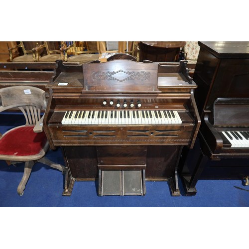 An Edwardian carved mahogany cased harmonium by the Estey Organ Company