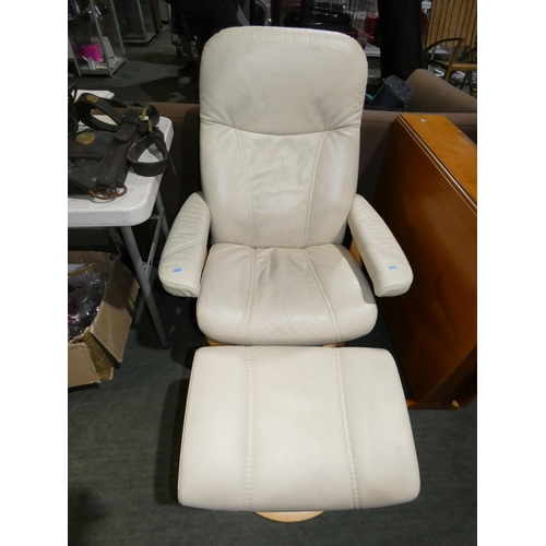 2179 - 1 Eknores cream leather upholstered stressless reclining swiveling lounge chair with a matching foot... 