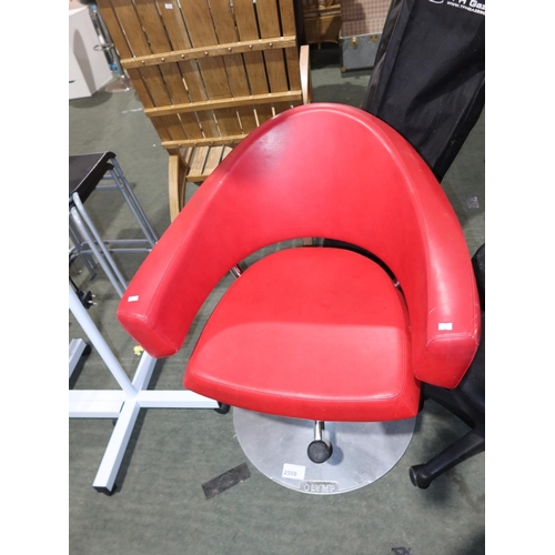 2559 - A red upholstered swivel foot operated salon chair by Olymp