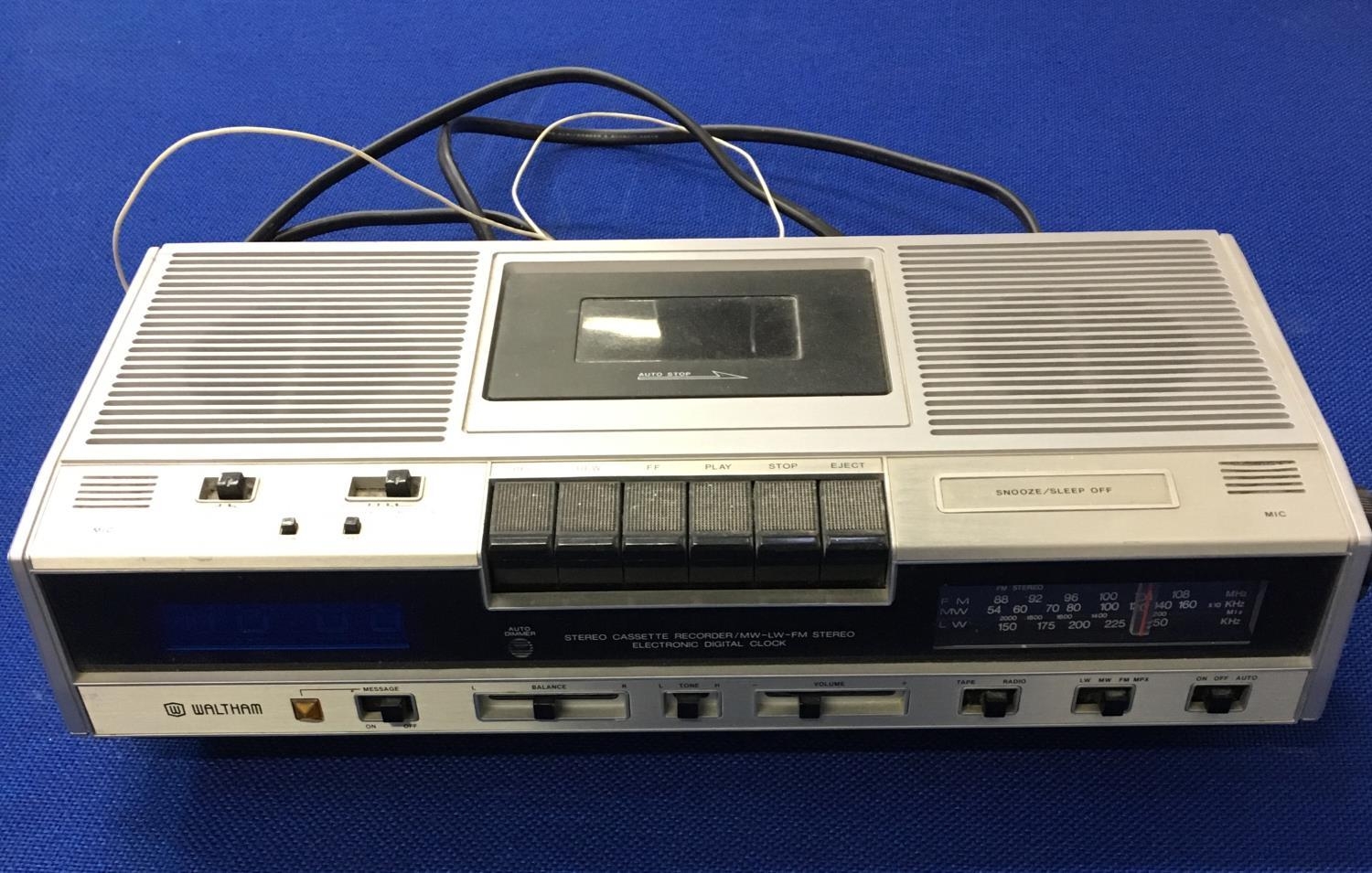 A vintage ClockRadio Cassette player, 4 cassette cases/holders