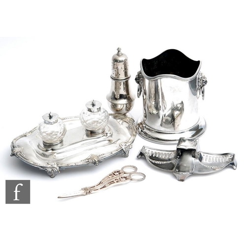 20 - A silver plated twin well desk stand with acanthus leaf details with a WMF ink well ice bucket, suga... 