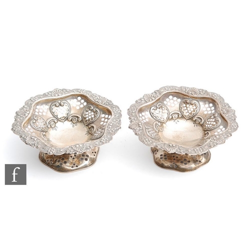 22 - A pair of hallmarked silver circular pedestal bon bon dishes, each with pierced decoration and termi... 