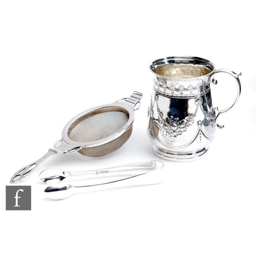 29 - An Edwardian hallmarked silver small tankard with embossed and engraved foliate swag decoration, wit... 