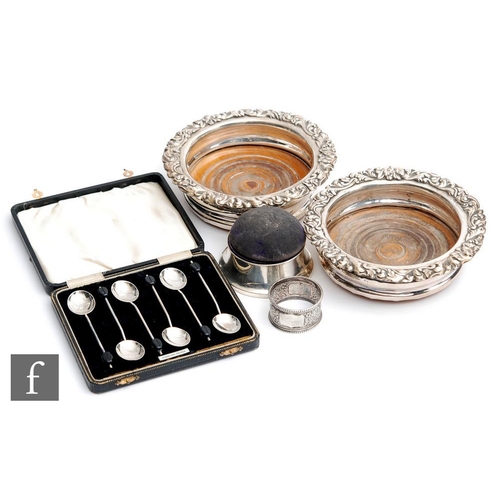 36 - A pair of silver plated bottle coasters with foliate decoration to borders, with a hallmarked silver... 