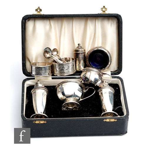 41 - A cased hallmarked silver three piece cruet set, Sheffield 1938, with three further condiments and t... 