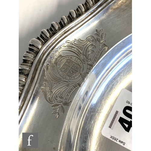 40 - A George IV hallmarked silver shallow plate of plain form with engraved crest within gadroon and she... 