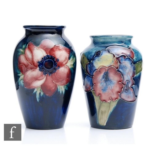 37 - Two small Moorcroft vases, the first decorated in the Anemone pattern, the second the Frilled Orchid... 