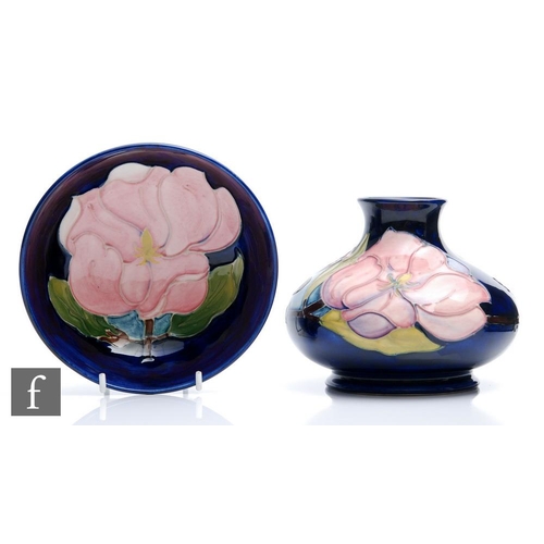 53 - A Moorcroft Pottery vase of compressed form decorated in the Magnolia pattern, impressed mark and in... 
