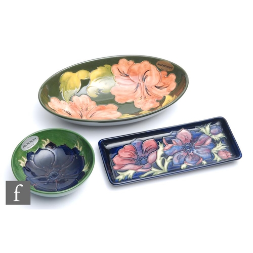 54 - Three pieces of Moorcroft Pottery comprising a rectangular pen tray decorated in the Anemone pattern... 