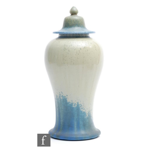 59 - A Ruskin Pottery Mei Ping shaped vase and cover decorated in a glossy light green to matt dark blue ... 