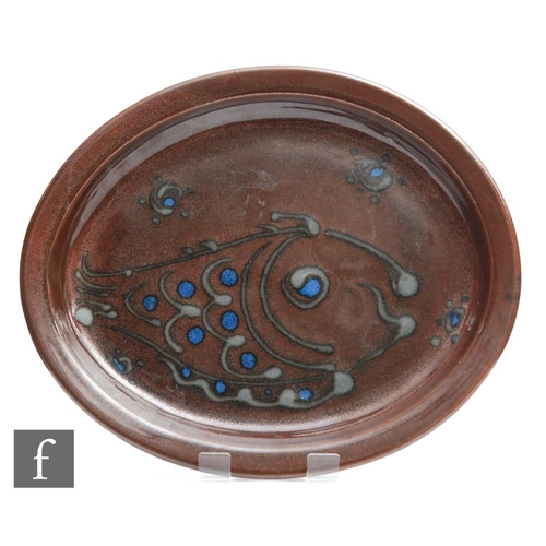 8 - A later 20th Century Winchcombe studio pottery oval dish decorated with a slip trailed fish in grey ... 