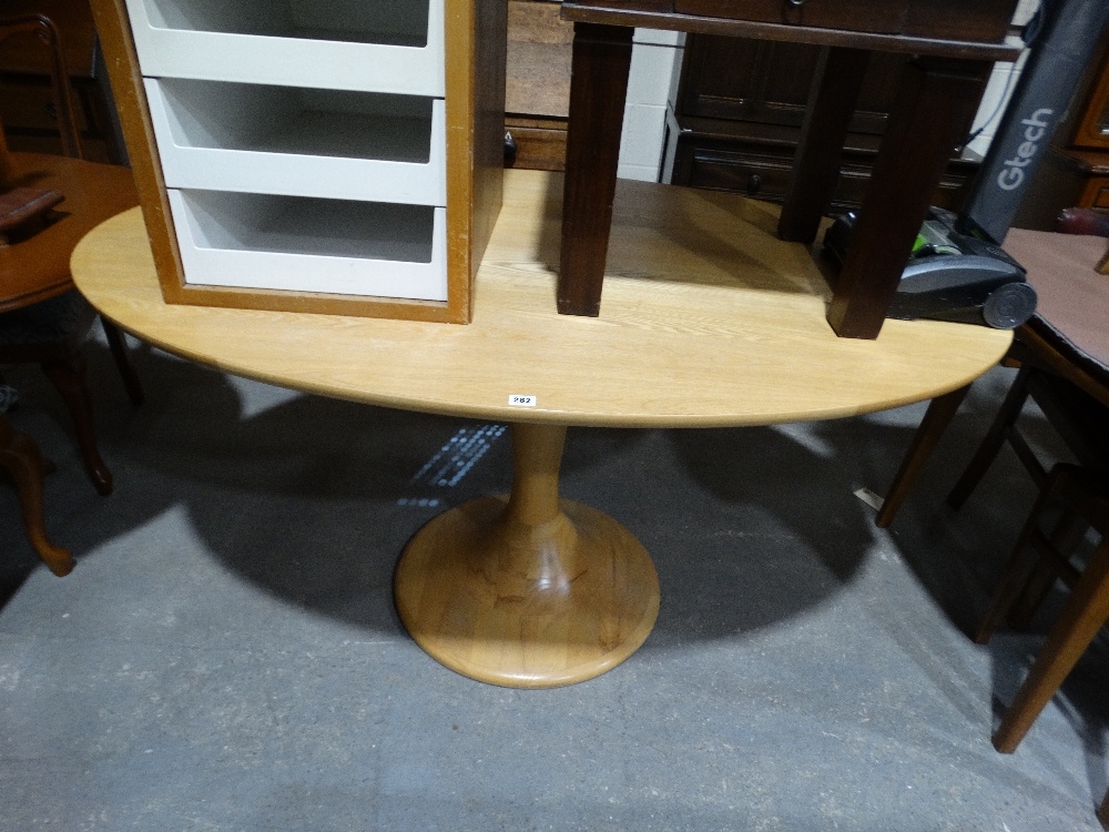An Oval Topped Ash Pedestal Dining Table