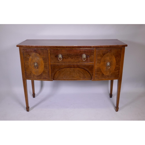 1160 - A Georgian III mahogany bowfront sideboard with two drawers flanked by two cupboards, raised on squa... 