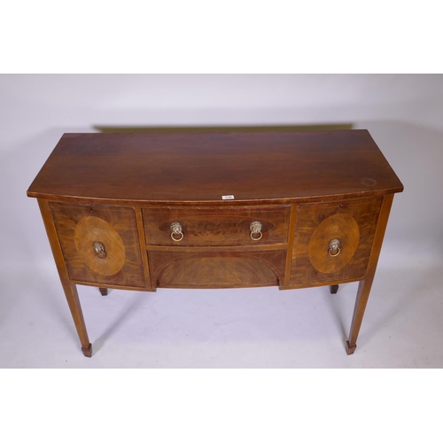 1160 - A Georgian III mahogany bowfront sideboard with two drawers flanked by two cupboards, raised on squa... 