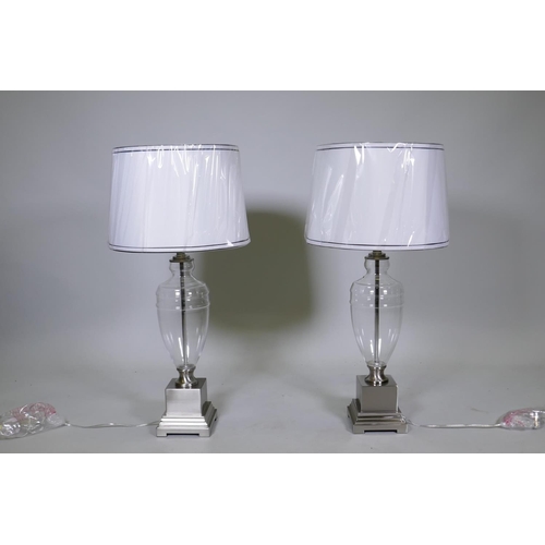 7 - A pair of contemporary brushed steel and glass table lamps with shades, unused, 33