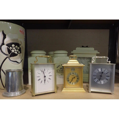 1034 - Selection of modern carriage clocks, three ceramic storage jars and a large ceramic vase. Not availa... 