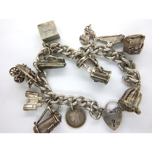 16 - Sterling silver charm bracelet with eleven charms and safety chain, L: 16 cm, 68g. P&P Group 1 (£14+... 