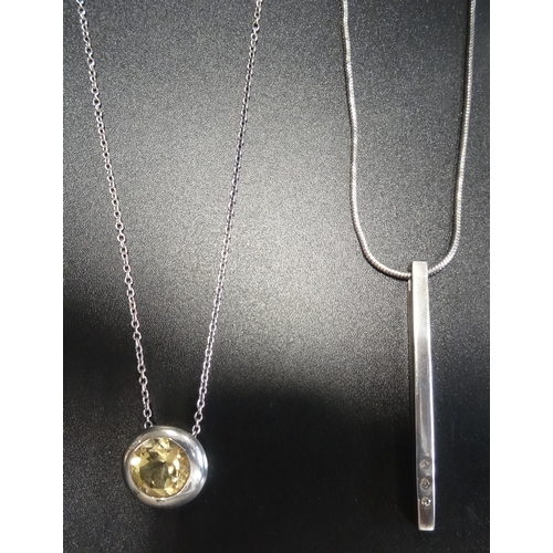 29 - DIAMOND SET DROP PENDANT
and a circular bezel set citrine pendant, both in silver and on silver chai... 