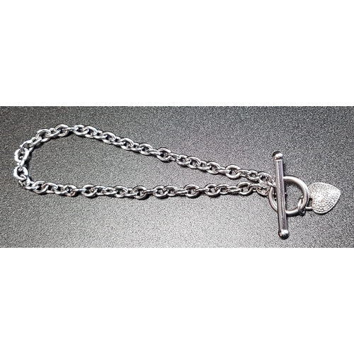3 - NINE CARAT WHITE GOLD BRACELET
the belcher link bracelet with T-bar clasp and diamond set heart char... 