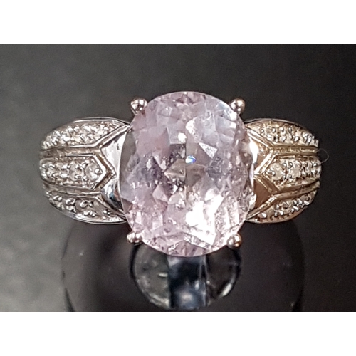 37 - KUNZITE AND DIAMOND DRESS RING
the central oval cut kunzite flanked by multi diamond set shoulders, ... 