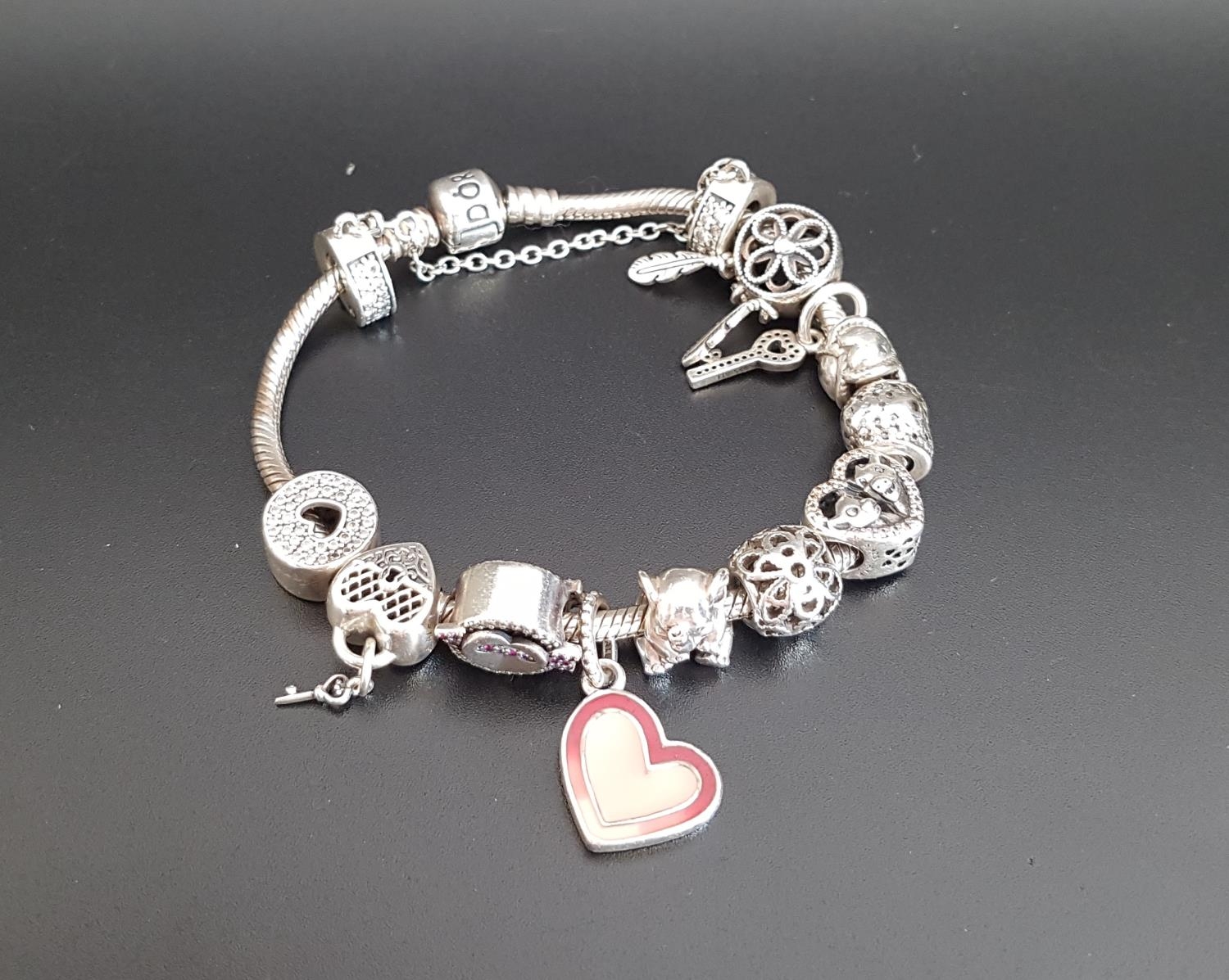 PANDORA MOMENTS SILVER CHARM BRACELET with a good selection of eleven
