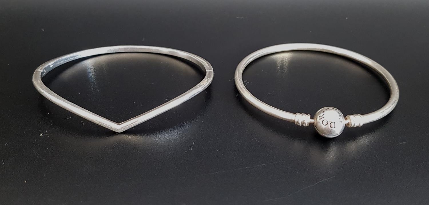 TWO PANDORA SILVER BRACLETS comprising a Moments charm bangle and a