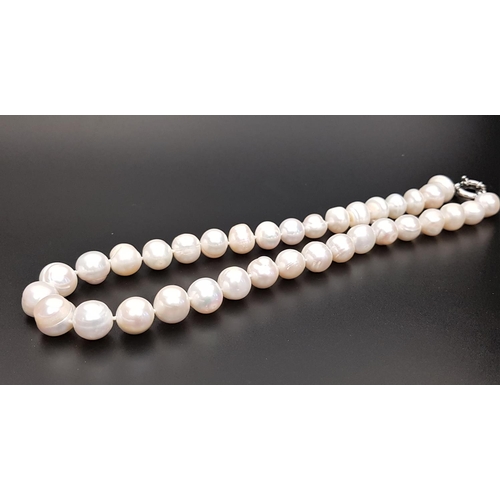 11 - WHITE FRESHWATER BAROQUE PEARL NECKLACE
with large individually knotted pearls, approximately 46cm l... 