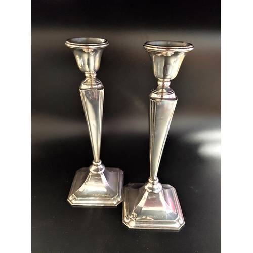 162 - PAIR OF GEORGE V SILVER CANDLESTICKS
with angular tapering stems raised on octagonal bases, Birmingh... 