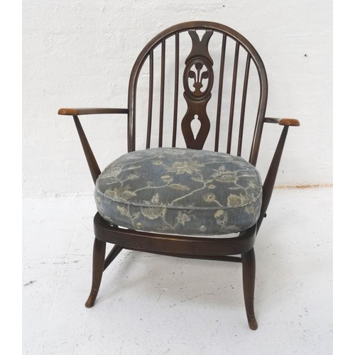 436 - ERCOL STICKBACK ARMCHAIR
the shaped back with a central splat above a pair of shaped arms with a cus... 