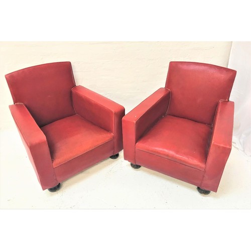 452 - PAIR OF CLUB ARMCHAIRS
covered in red vinyl, standing on flattened bun feet with castors (2)