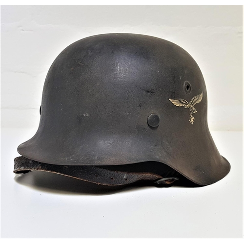 327 - GERMAN WWII HELMET
with original transfer of the eagle carrying the swastika to one side, with leath... 