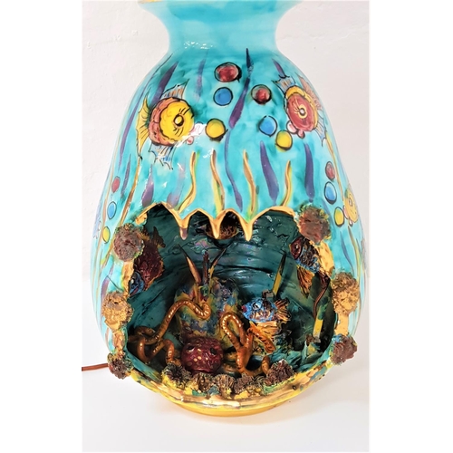 212 - 1960'S KERIMA GUALDOT POTTERY LAMP
decorated in aquamarine blue with vibrant fish, with a cut out se... 
