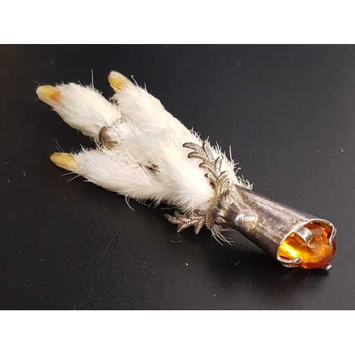 101 - GROUSE FOOT BROOCH
the silver plated mount decorated with stag head and set with amber coloured glas... 