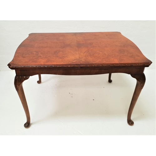 405 - FIGURED WALNUT DINING TABLE
with a shaped pull apart top and extra leaf, standing on cabriole suppor... 