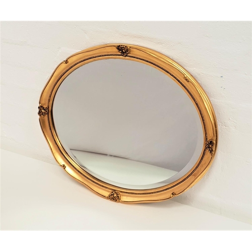 422 - OVAL GILTWOOD WALL MIRROR
with an oval beveled plate, 56.5cm wide