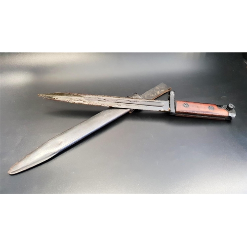 330 - ITALIAN BAYONET
with wood grip and fullered 24.5cm blade, with a metal scabbard