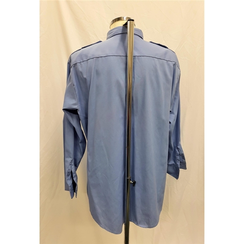 15 - BLUE SHIRT - UNKNOWN PRODUCTION 
65% polyester 35% cotton light blue shirt, fits X-Large